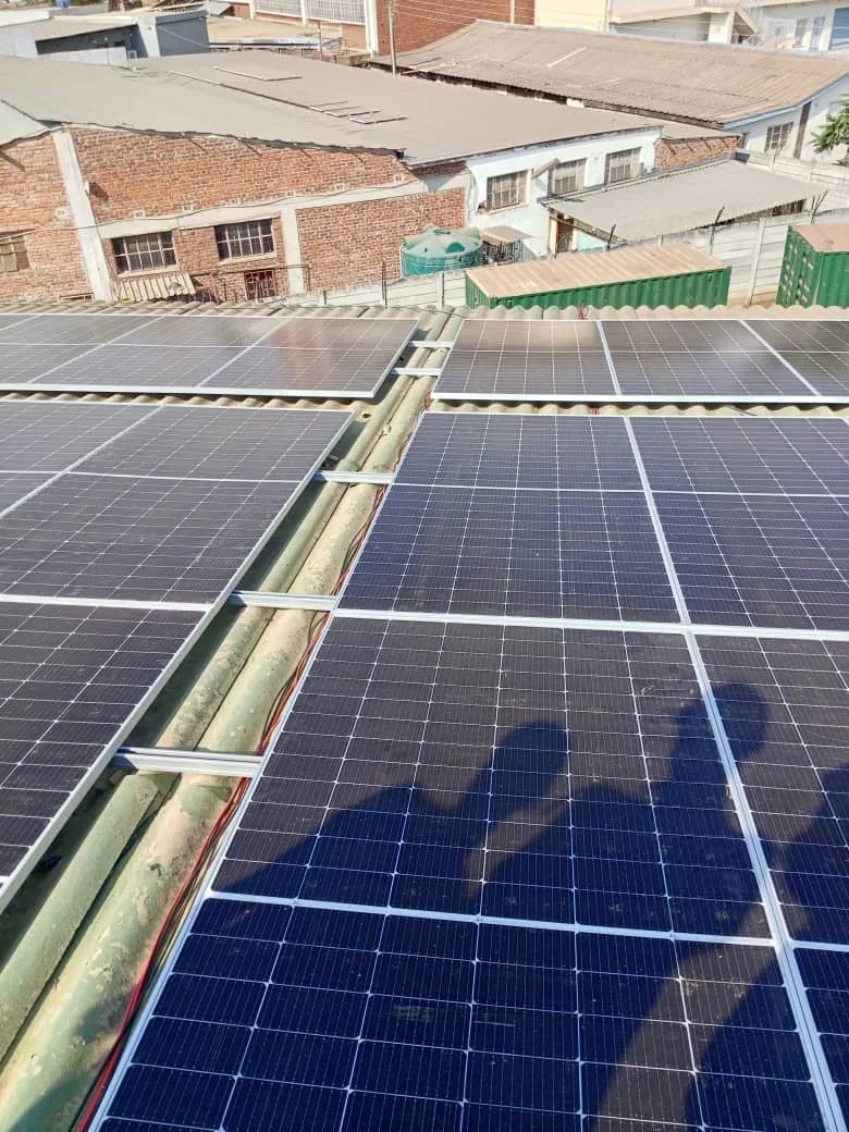 Solar photovoltaic panel array installed on an industrial roof in Zimbabwe